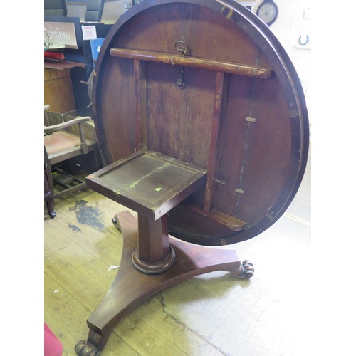 546A - A Victorian Mahogany Tilt Top Circular Dining Table with a tripod base and scroll/lion claw feet.
di... 