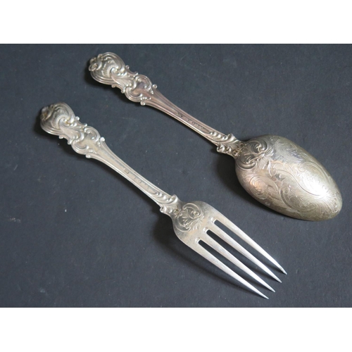 129 - A Victorian Silver Desert Spoon and Fork, the back of the spoon bowl with chased foliate scroll deco... 