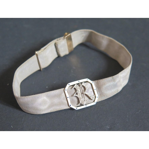 220G - A Victorian Diamond, Enamel and Gold (unmarked) Silk Band Bracelet decorated with the initial R