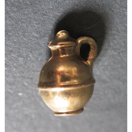 220M - A 9ct Gold Jug Charm, 0.9g