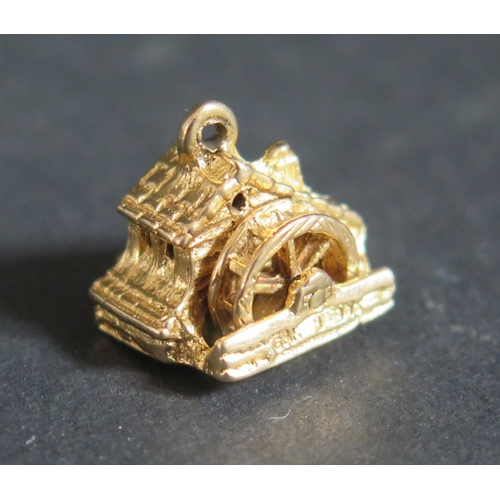 220P - A 9ct Gold Articulated Water Mill Charm, 4.3g