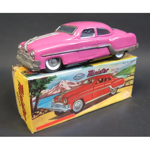 283 - A Minister Delux Fiction Tinplate Toy Car in Deep Pink. Near mint in worn box.