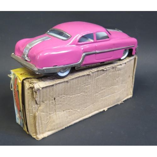 283 - A Minister Delux Fiction Tinplate Toy Car in Deep Pink. Near mint in worn box.