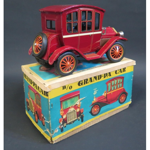 284 - A TN Nomura Japan Battery Operated Tinplate Grand-Pa Car. Excellent (untested) in worn box.