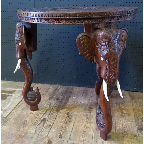 1081 - An Indian Carved Occasional Table with elephant mask legs, 61.5cm diam.