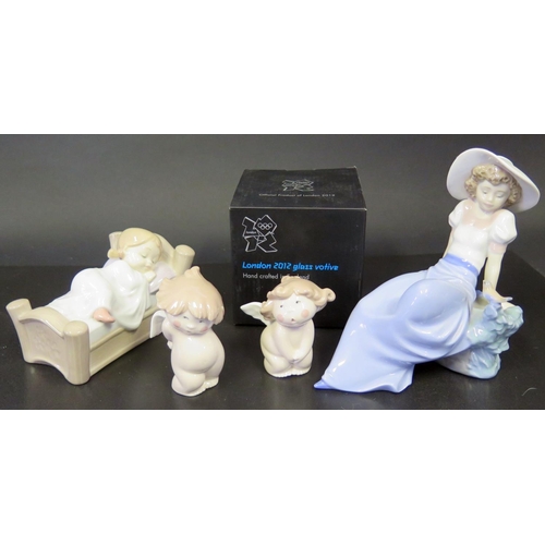 739 - A Lladro Figurine, Four Boxed Nao Figurines and London 2012 Glass Votive