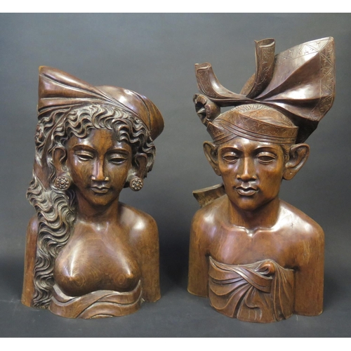 748 - A Pair of Bali Carved Treen Busts of a female and male, signed KLUNGKUNG, tallest 34cm