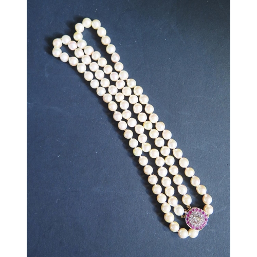 892 - A Twin Strand Pearl Choker with a rose cut diamond and ruby clasp, the central stone with a maximum ... 