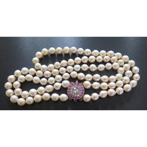 892 - A Twin Strand Pearl Choker with a rose cut diamond and ruby clasp, the central stone with a maximum ... 