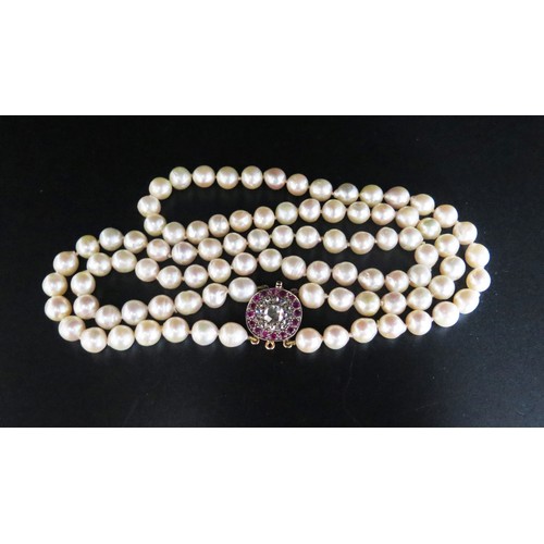 892 - A Twin Strand Pearl Choker with a rose cut diamond and ruby clasp, the central stone with a maximum ... 