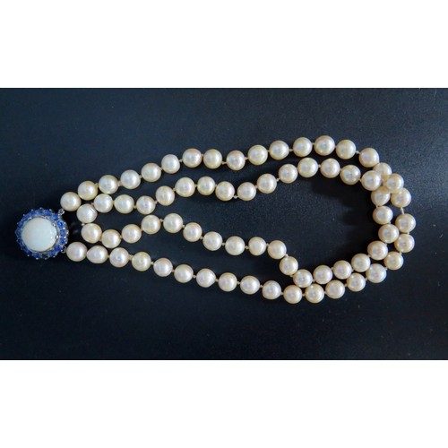 893 - A Single Strand Pearl Necklace with a large white opal and blue stone pendant, the 15.5mm singlet op... 