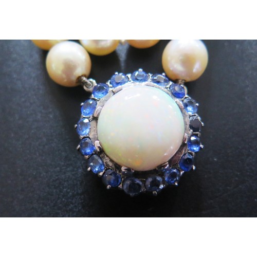 893 - A Single Strand Pearl Necklace with a large white opal and blue stone pendant, the 15.5mm singlet op... 