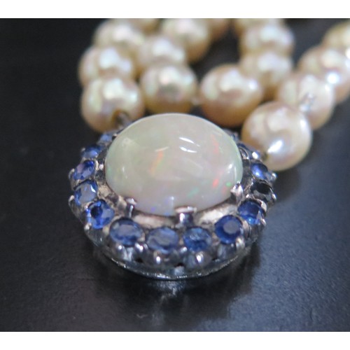 893 - A Single Strand Pearl Necklace with a large white opal and blue stone pendant, the 15.5mm singlet op... 