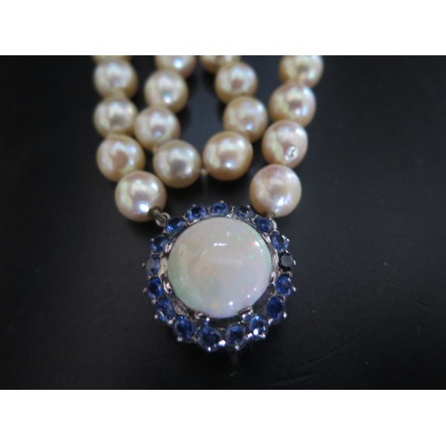 893 - A Single Strand Pearl Necklace with a large white opal and blue stone pendant, the 15.5mm singlet op... 