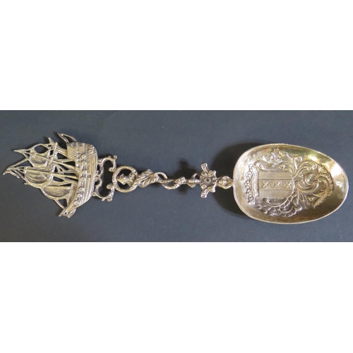 1051 - A Large Continental Silver Decorative Spoon, the bowl decorated with an armorial bearing three verti... 