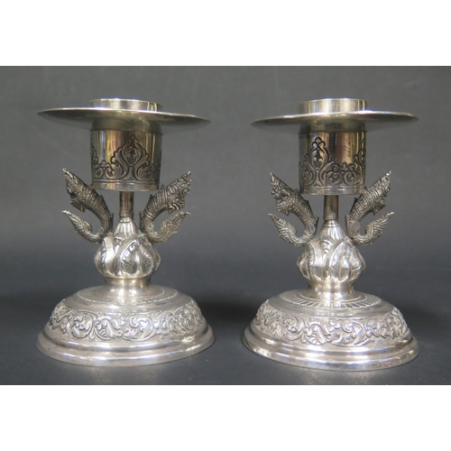 1089 - A Pair of Cambodian Silver Candlesticks with fish flanked stems, 10.5cm, 263g