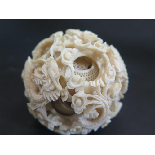 1174 - An Antique Chinese Carved Ivory Puzzle Ball carved with dragons and with approximately 15 layers (c.... 