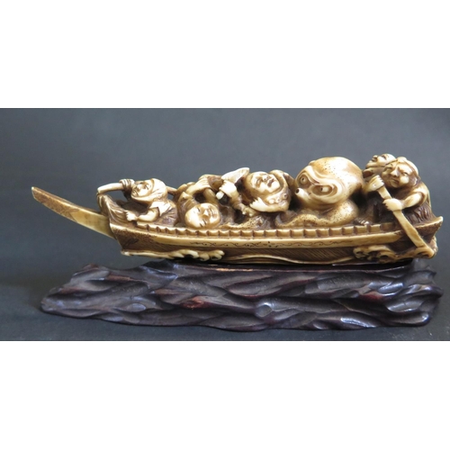 1185 - An Antique Japanese Carved Ivory Katabori Netsuke in the form of a fishing boat with five fishermen ... 