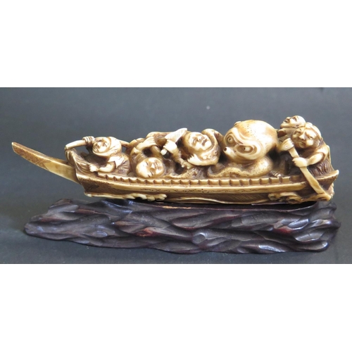 1185 - An Antique Japanese Carved Ivory Katabori Netsuke in the form of a fishing boat with five fishermen ... 