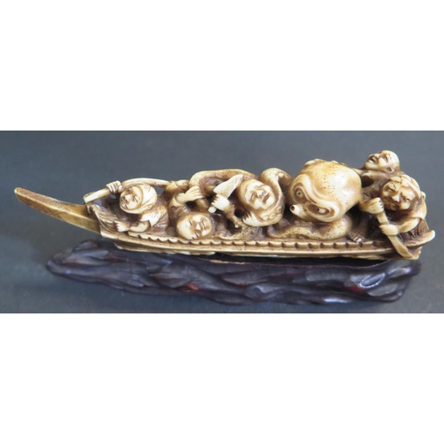 1185 - An Antique Japanese Carved Ivory Katabori Netsuke in the form of a fishing boat with five fishermen ... 