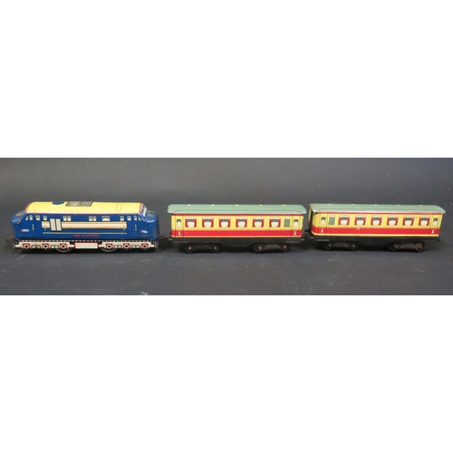 326 - An Electric Brimtoy Tinplate D5001 Diesel Locomotive and Carriages. Carriages are sun faded on one s... 