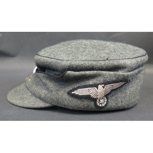 497 - A German WWII Army Field Cap with SS Totenkopf Skull badge and eagle cloth badge to side, inside wit... 