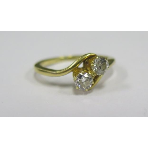 879 - A Diamond Two Stone Crossover Ring dated 19/11/13, hallmarks rubbed but appears to be 18ct, size J, ... 