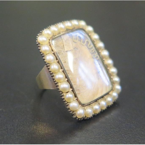 881 - A Georgian Gold Memorial Ring set with lock of hear, gold thread and bordered by pearls, size A, 5.1... 