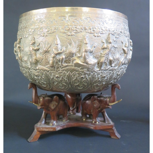 982 - A Large Burmese Silver Thabeik Bowl decorated figures in various poses with foliate scroll borders a... 