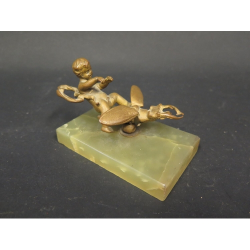 1110 - A Bronze Model of Cupid Riding a Beetle and on an onyx base, 10cm base.Three legs missing