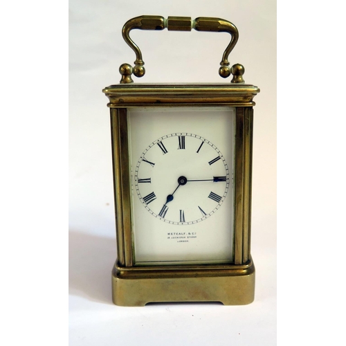 1221 - A Metcalf & Co. Brass Carriage Clock with balance wheel to the back, 13cm to top of handle, running