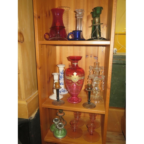 1633 - A Victorian Cranberry Glass Vase and collection of glass and ceramic candlesticks