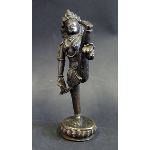 1064 - An Indian Bronze Figure of Hindu Figure with raised leg and standing on lotus blossom, 15cm