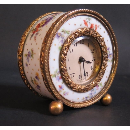 1225 - A Floral Porcelain and Gilt Clock, running, 9.5cm diam.