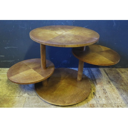 1240 - An Oak Veneered Four Tier Table, the central two tiers with adjustable swivel, 65diam. x 65 high cm