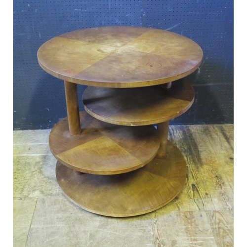 1240 - An Oak Veneered Four Tier Table, the central two tiers with adjustable swivel, 65diam. x 65 high cm