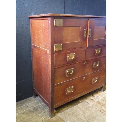 1281 - An Arts & Crafts Oak Chest of Three Drawers with twin door cupboard over  in an American configurati... 