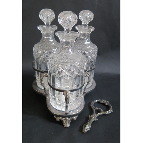 1461 - A Three Decanter Set in plated stand. Plated stand damaged, one bottle with chip to rim and one stop... 