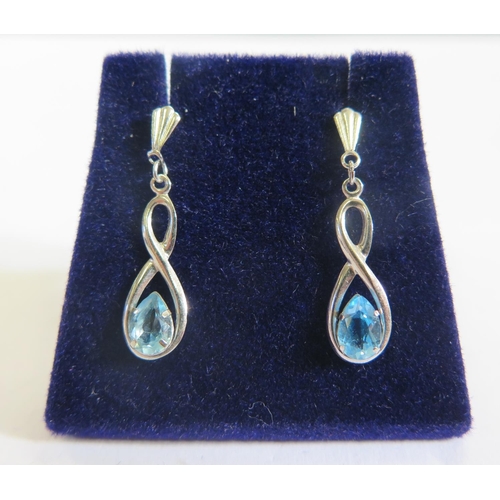 155 - A Pair of White Gold and Blue Topaz Pendant Earrings