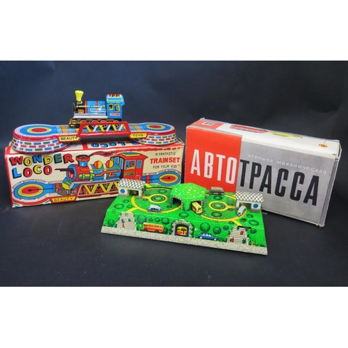 1785 - An Agracol Beauty Toys Wonder Loco Trainset and Abtotpacca Tinplate Clockwork Road Layout. Both in g... 