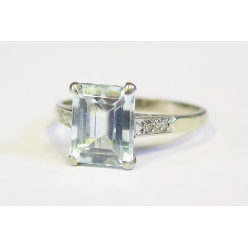 236 - A White Gold and Aqua Marine Ring set with two diamonds to each shoulder (unmarked setting), size O.... 