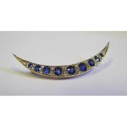 323 - A Victorian Sapphire and Diamond Crescent Brooch in an un unmarked high carat gold setting, 53.5mm, ... 