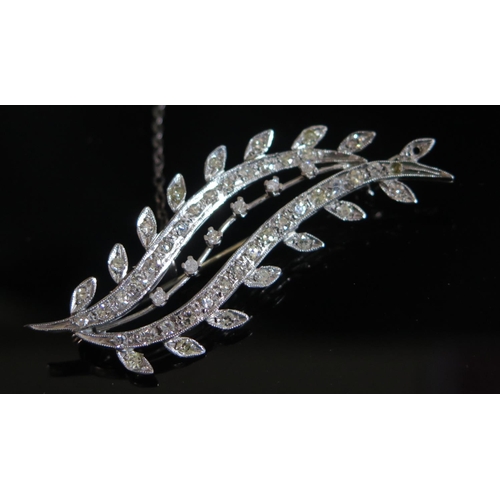 334 - A Diamond Floral Spray Brooch in an unmarked white gold setting, one stone missing, 63mm, 9.5g