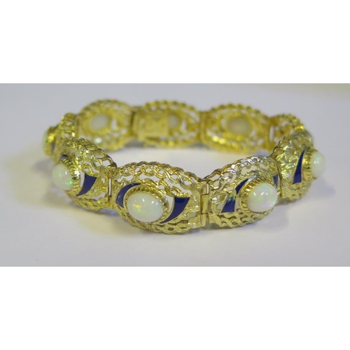 335 - An 18ct Yellow Gold, White Opal and Blue Enamel Bracelet, 18cm long x 1.5cm wide, opals c. 9x6mm, 26... 