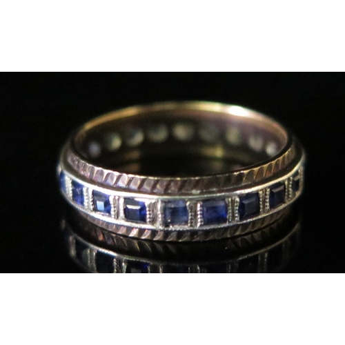 394 - A Sapphire Eternity Ring in a white and yellow metal setting, size O, 3.7g