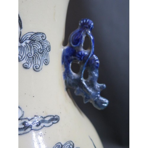 1024A - A 19th Century Chinese Porcelain Vase decorated with Foo Dogs, 42cm high. One handle restored