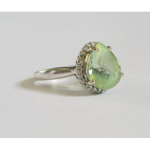 98 - An 18ct White Gold Ring set with Pale Green Pear Cut Stone and Diamond Surround, size N, 3.6g