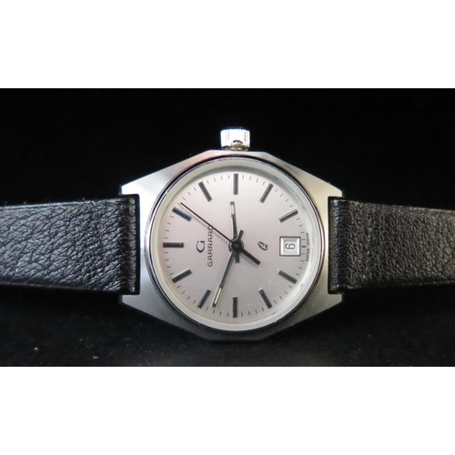 383 - A Cased Ladies GARRARD Q Steel Cased Quartz Wristwatch, appears unworn. Needs new battery