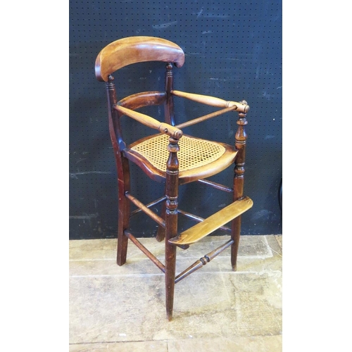 1499 - A Victorian Mahogany Cane Seated Child's High Chair. Old worm to arm