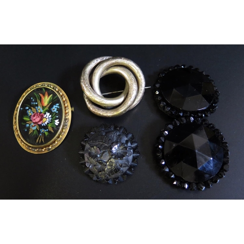 132 - A Victorian Whitby Jet Foliate Carved Brooch (38mm diam.), glass buckle and two vintage brooches